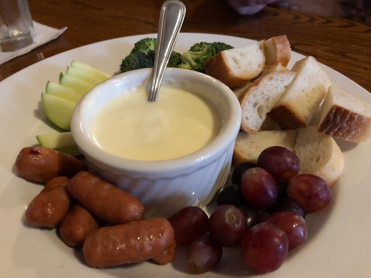 The appetizer fondue is a must from Woody’s Library Restaurant!